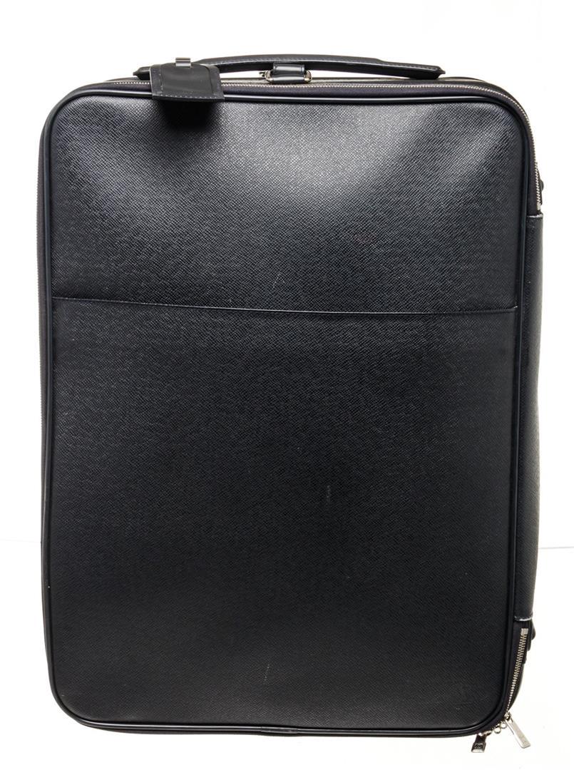 Louis Vuitton Black Leather Pegase 50 Travel Bag: Louis Vuitton Black Leather Pegase 50 Travel Bag with leather, gold-tone hardware, trim tan vachetta leather, interior card holder pockets, canvas lining, top handle and zipper closure.