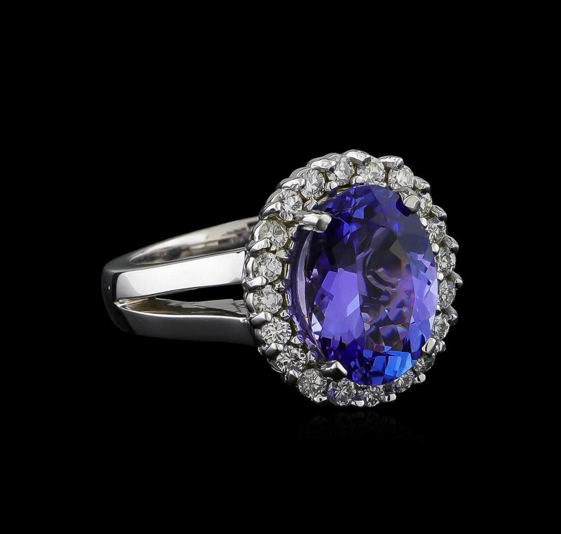 4.25 ctw Tanzanite and Diamond Ring - 14KT White Gold: One electronically tested 14KT white gold lady's cast fashion ring with a basket halo with a bright polish finish. The featured lady's ring has a shank measuring 3.17 millimeters wide. Identified with