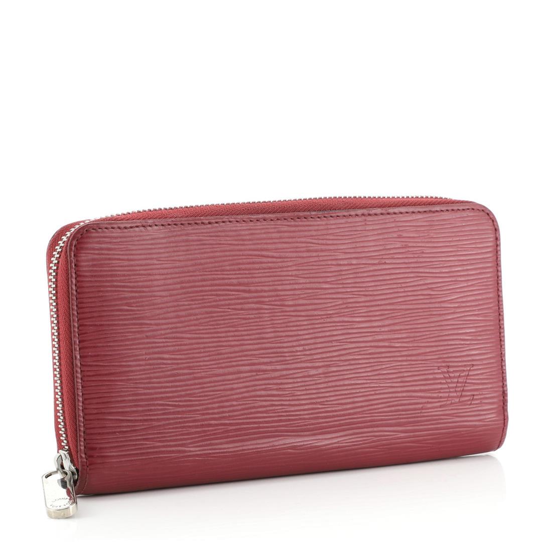 Louis Vuitton Red Epi Leather Zippy Wallet: Louis Vuitton Red Epi Leather Zippy Wallet with silver-tone hardware, tonal leather interior, five compartments; one with zip closure, dual bill compartments, eight card slots and zip-around closure a