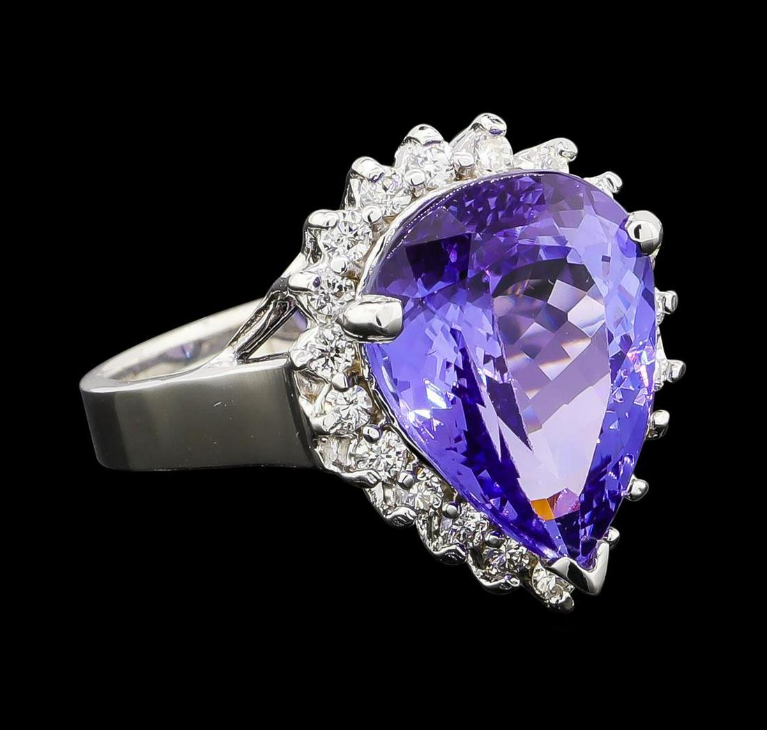 6.36 ctw Tanzanite and Diamond Ring - 14KT White Gold: One electronically tested 14KT white gold lady's cast fashion ring with a basket halo with a bright polish finish. The featured lady's ring has a shank measuring 3.04 millimeters wide. Identified with