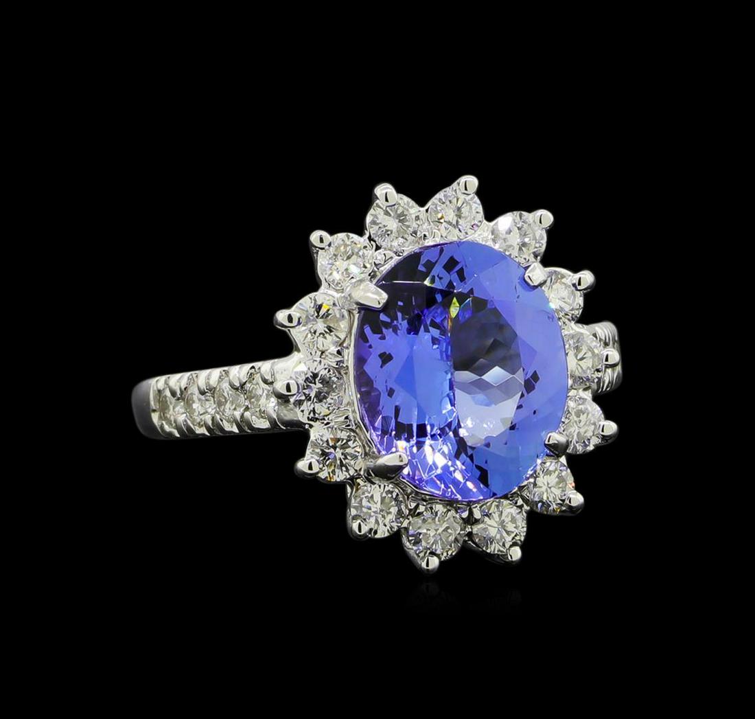 3.37 ctw Tanzanite and Diamond Ring - 14KT White Gold: One electronically tested 14KT white gold lady's cast fashion ring with a basket halo with a bright polish finish. The featured lady's ring has a shank measuring 1.90 millimeters wide. Identified with