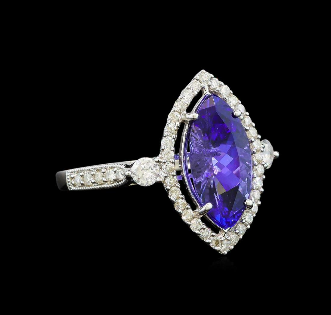 14KT White Gold 2.66 ctw Tanzanite and Diamond Ring: One electronically tested 14KT white gold ladies cast tanzanite and diamond ring with a bright polish finish. Identified with markings of "14K". Condition is new. Containing: One prong set marquise mo