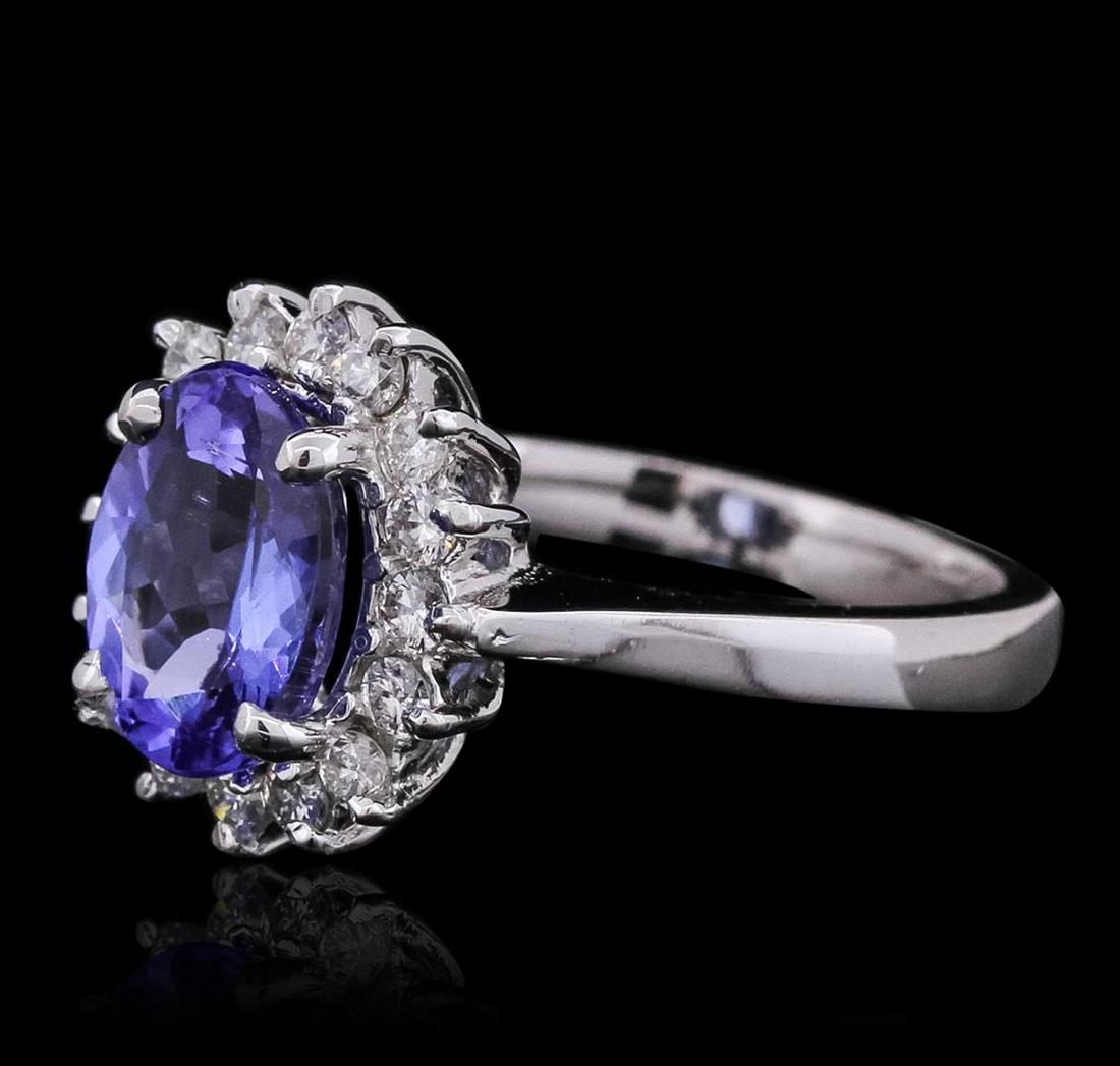 14KT White Gold 2.37 ctw Tanzanite and Diamond Ring: One electronically tested 14KT white gold ladies cast tanzanite and diamond ring with a bright polish finish. The featured tanzanite is set within a diamond bezel, completed by a two and one-half mill