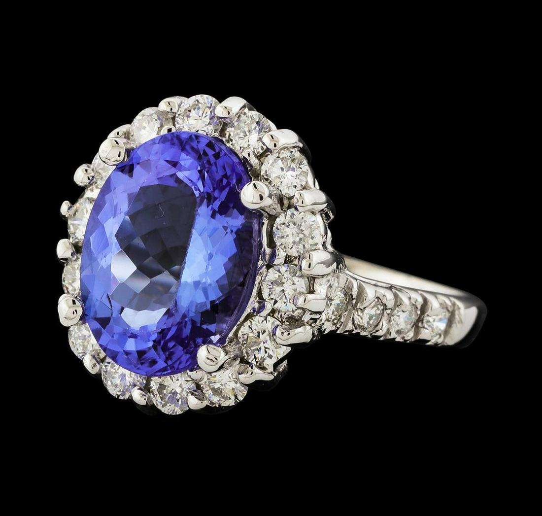 4.13 ctw Tanzanite and Diamond Ring - 14KT White Gold: One electronically tested 14KT white gold lady's cast fashion ring with a cathedral shank with a basket halo with a bright polish finish. The featured lady's ring has a shank measuring 1.53 millimeter