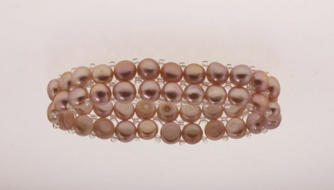 6.5" Cultured Champagne Pink Pearl Bracelet PS47: 6.5 Cultured Champagne Pink Pearl Bracelet PS47. Excellent Condition! HG3QG. One approx. 6.5" champagne colored cultured pearl bracelet. Stretches for adjusting to different sizes of wrists, with 2 ro