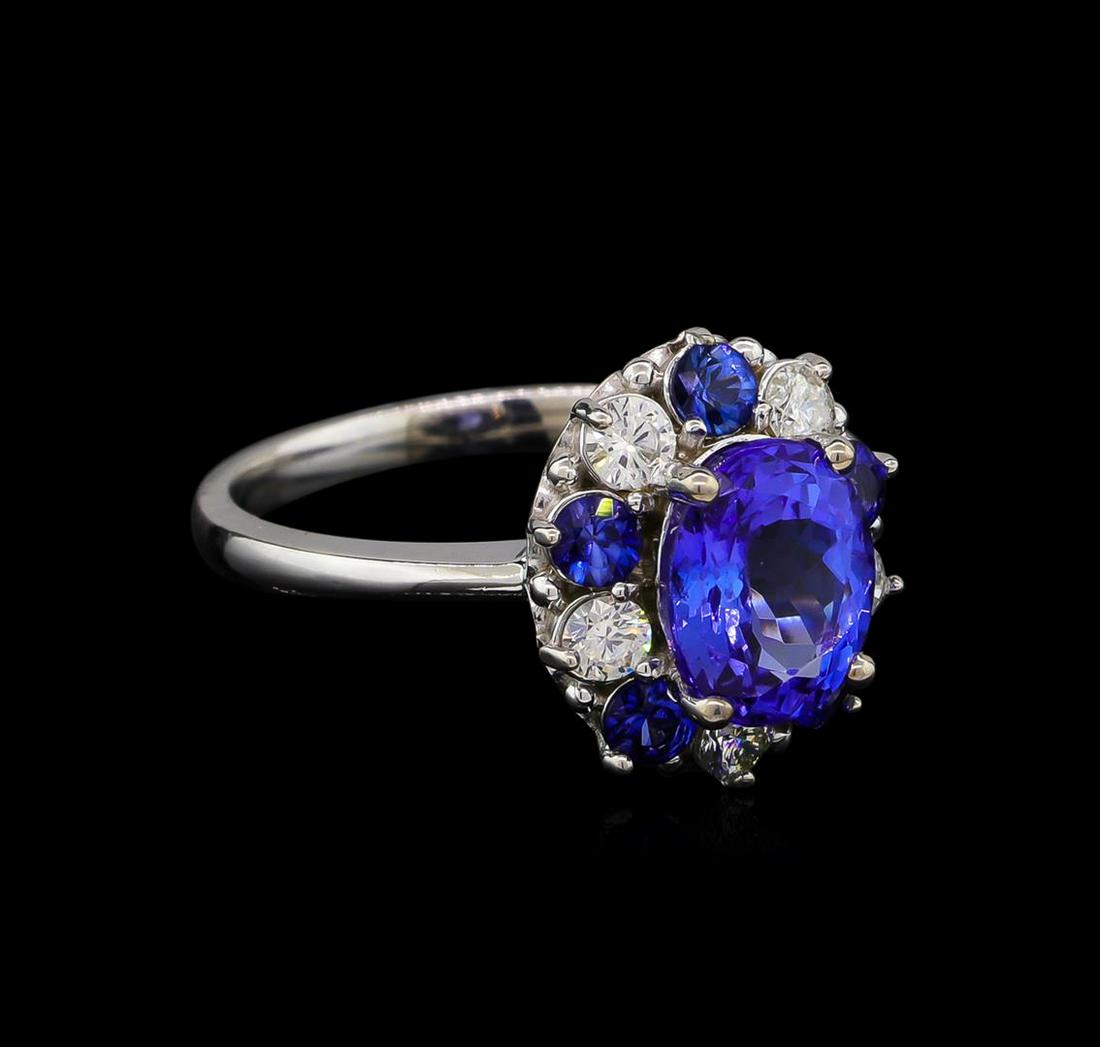 2.55 ctw Tanzanite, Sapphire and Diamond Ring - 14KT White Gold: One ring featuring: 14KT white gold weighing 3.80 grams containing one tanzanite with a total weight of 2.55ct and 5 blue sapphires with a total weight of 0.55ct and side diamonds with a total weight 