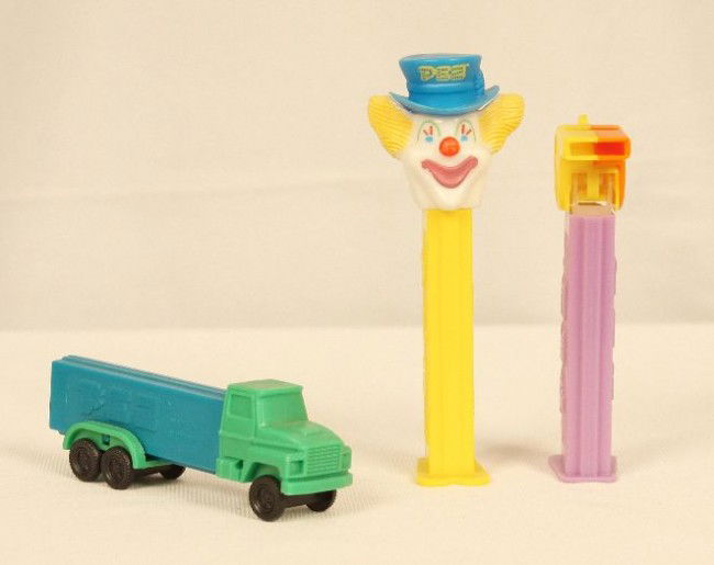 Lot of 3 Truck-D, Coach Whistle, and Peter PEZ Dispense: "Lot of 3 Truck-D, Coach Whistle, and Peter PEZ Dispensers ED944. As-Is Condition! HW3FS. Lot of 3 PEZ dispensers. Included are a 1991 "Truck-D", 1993 "Peter Pez", and one 4.9 "Coach Whistle" Orange o