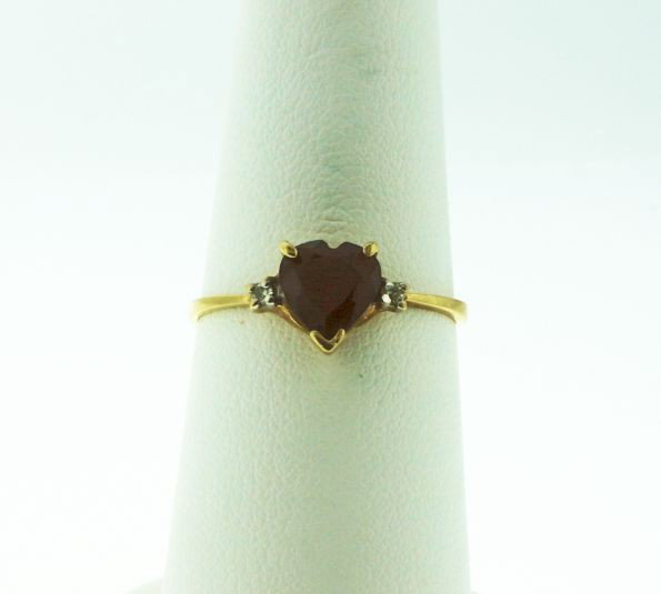 10KT Yellow Gold Heart Garnet & Diamond Ring GD62: 10KT Yellow Gold Heart Garnet & Diamond Ring GD62. Good Condition! PE93OL. One 10KT yellow gold heart garnet accented with diamonds ring weighing 1.3g. Total weight of Diamonds: .10ctw. Thank you for 
