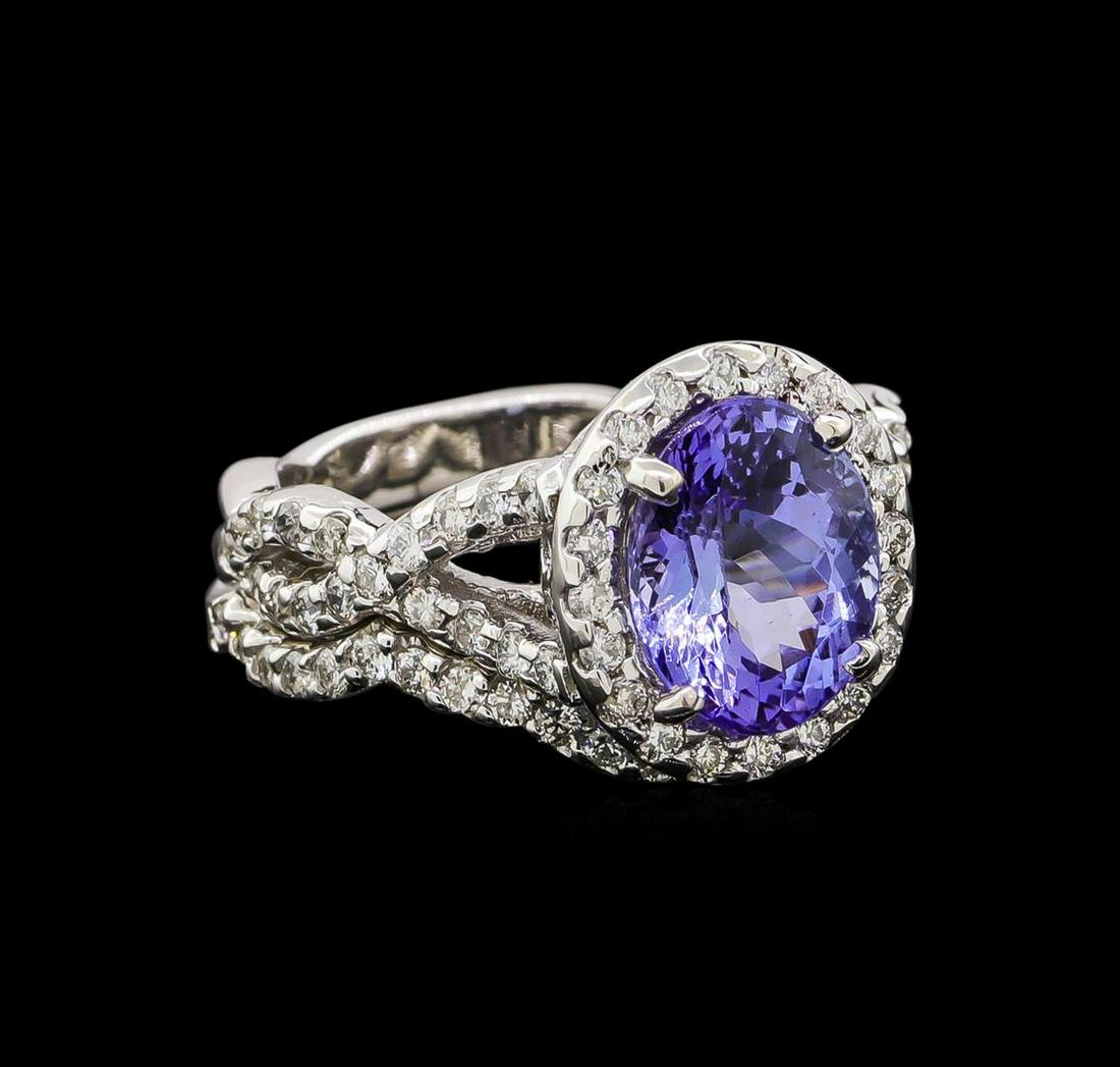 14KT White Gold 2.37 ctw Tanzanite and Diamond Ring and Guard: One electronically tested 14KT white gold ladies cast tanzanite and diamond ring and guard with a bright polish finish. Identified with markings of "14K". Condition is new. Containing: One prong set o