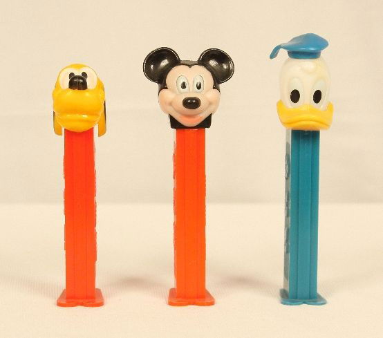 Lot of 3 Walt Disney PEZ Dispensers ED945: Lot of 3 Walt Disney PEZ Dispensers ED945. Excellent Vintage Condition! PQ3CD. Lot of 3 Walt Disney PEZ dispensers. Included are one 4.9 Mickey Mouse", one 4.9 "Pluto", and one 3.9 "Donald Duck". Come
