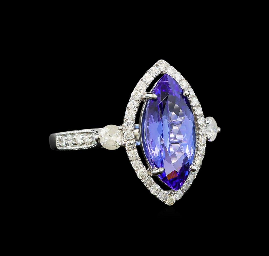 14KT White Gold 2.78 ctw Tanzanite and Diamond Ring: One electronically tested 14KT white gold ladies cast tanzanite and diamond ring with a bright polish finish. Identified with markings of "14K". Condition is new. Containing: One prong set marquise mo