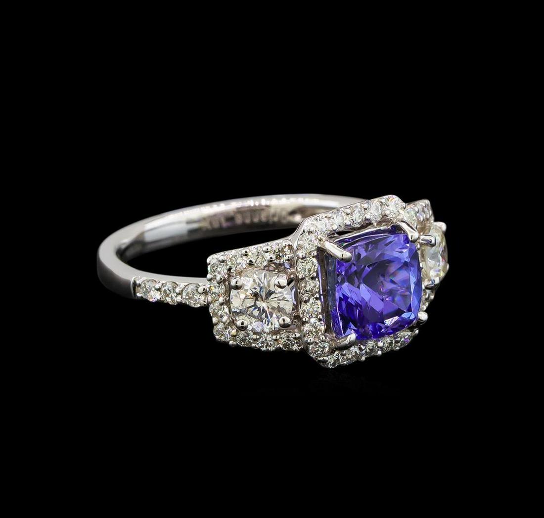 18KT White Gold 1.41 ctw Tanzanite and Diamond Ring: One electronically tested 18KT white gold ladies cast tanzanite and diamond ring with a half round shank with a bright polish finish. Identified with markings of "18K". Condition is new. Containing: O