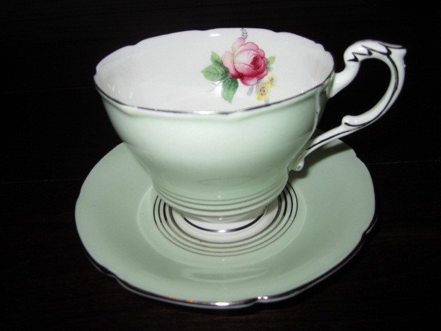 Paragon China- beautiful Cup & Saucer Set BD70: "Paragon China- beautiful Cup & Saucer Set BD70. Excellent Vintage Condition! RT14PT. The cup and saucer are a very pretty soft green with silver "pin stripes" and trim along the scalloped edges, rim,