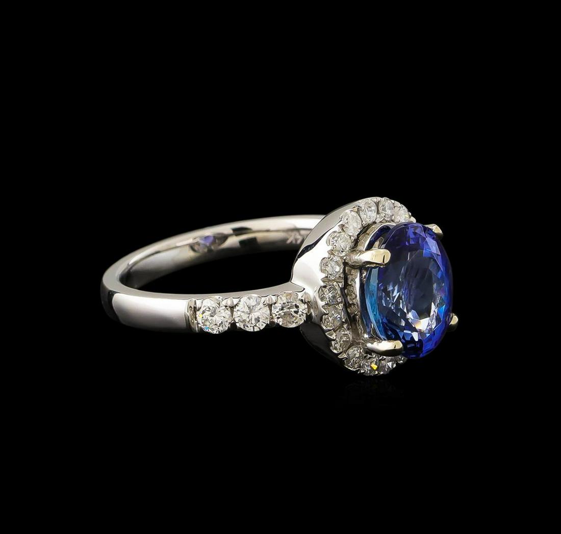 2.65 ctw Tanzanite and Diamond Ring - 14KT White Gold: One electronically tested 14KT white gold ladies cast tanzanite and diamond ring with a bright polish finish. The featured tanzanite is set within a diamond bezel supported by diamond set shoulders, c