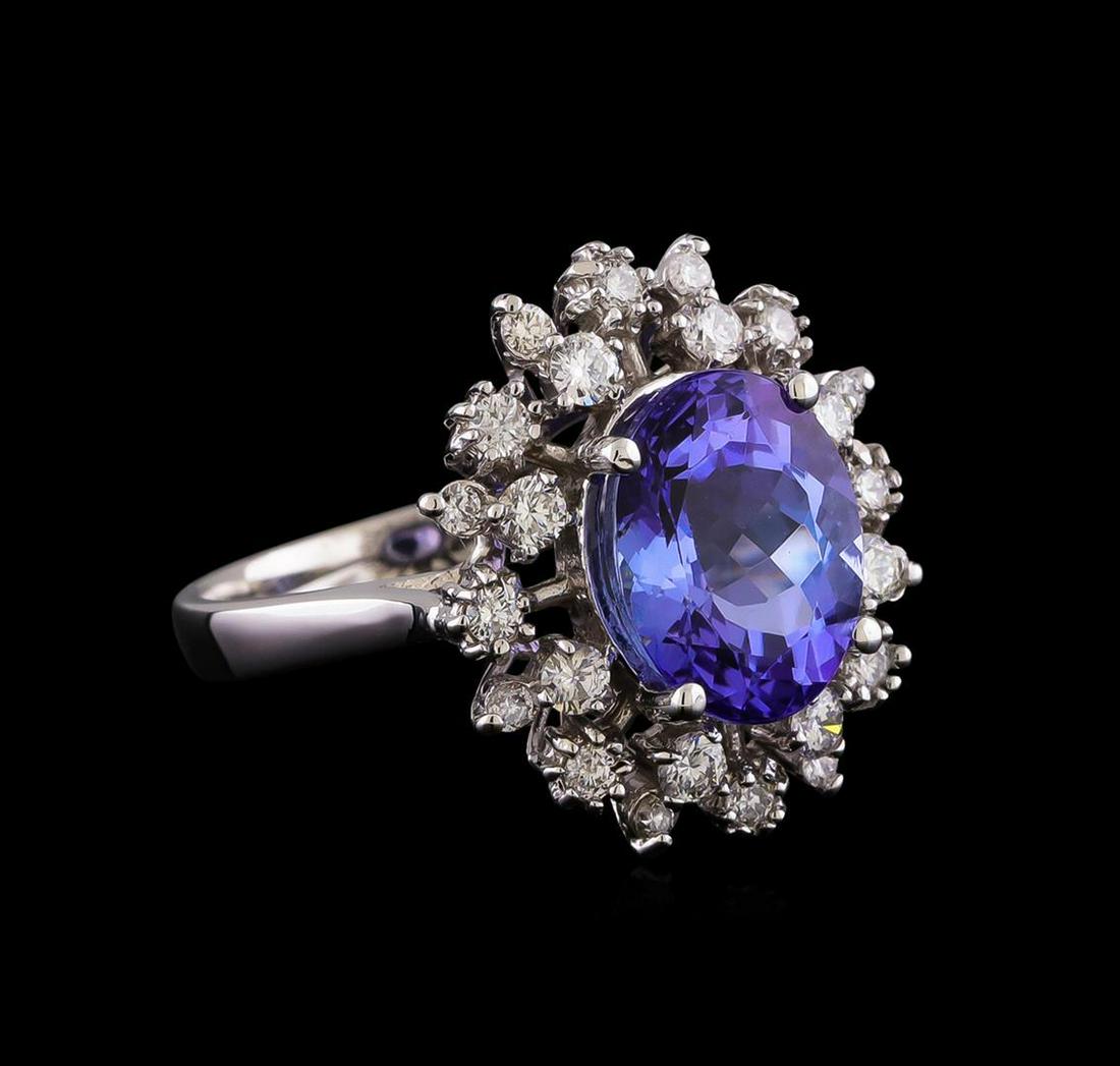 4.35 ctw Tanzanite and Diamond Ring - 14KT White Gold: One electronically tested 14KT white gold lady's cast fashion ring with a basket double halo with a bright polish finish. The featured lady's ring has a shank measuring 2.69 millimeters wide. Identifi