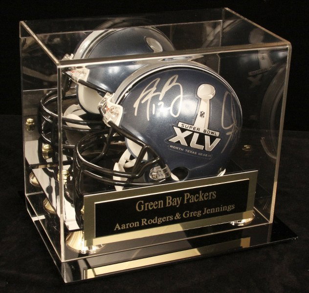 Two Green Bay Packers Autographed Mini Helmet SM7: "Two Green Bay Packers Autographed Mini Helmet SM7. Excellent Condition! RJ18BG. This mini helmet is signed by Superbowl winners and Green Bay Packers Aaron Rodgers and Greg Jennings. Comes with displ