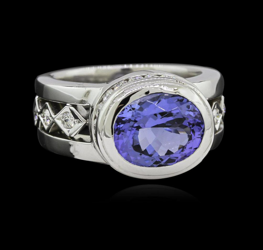 3.78 ctw Tanzanite and Diamond Ring - 18KT White Gold: One electronically tested 18KT white gold lady's combination cast & assembled fashion ring with a three row wide band with a bright polish finish. The featured lady's ring has a triple shank measuring