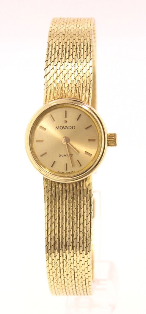 14KT Yellow Gold Movado Ladies Quartz Wristwatch A3141: "14KT Yellow Gold Movado Ladies Quartz Wristwatch A3141. As Is Condition! EA125JM. 14KT yellow gold Movado ladies quartz wristwatch. It is in working condition. Comes with original box and papers. Tha