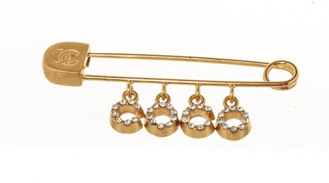 Chanel Gold Logo Safety Pin: Chanel Gold Logo Safety Pin with gold-tone hardware and push lock closure.