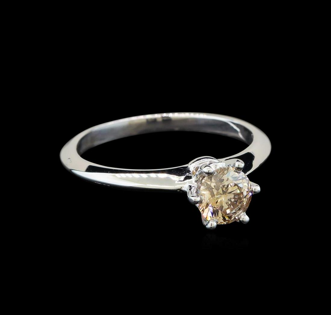14KT White Gold 0.70 ctw Round Cut Fancy Brown Diamond Solitaire Ring: One electronically tested 14KT white gold ladies cast diamond solitaire ring with a knife edge shank with a bright polish finish. Identified with markings of "14K". Condition is new. Containing: One p