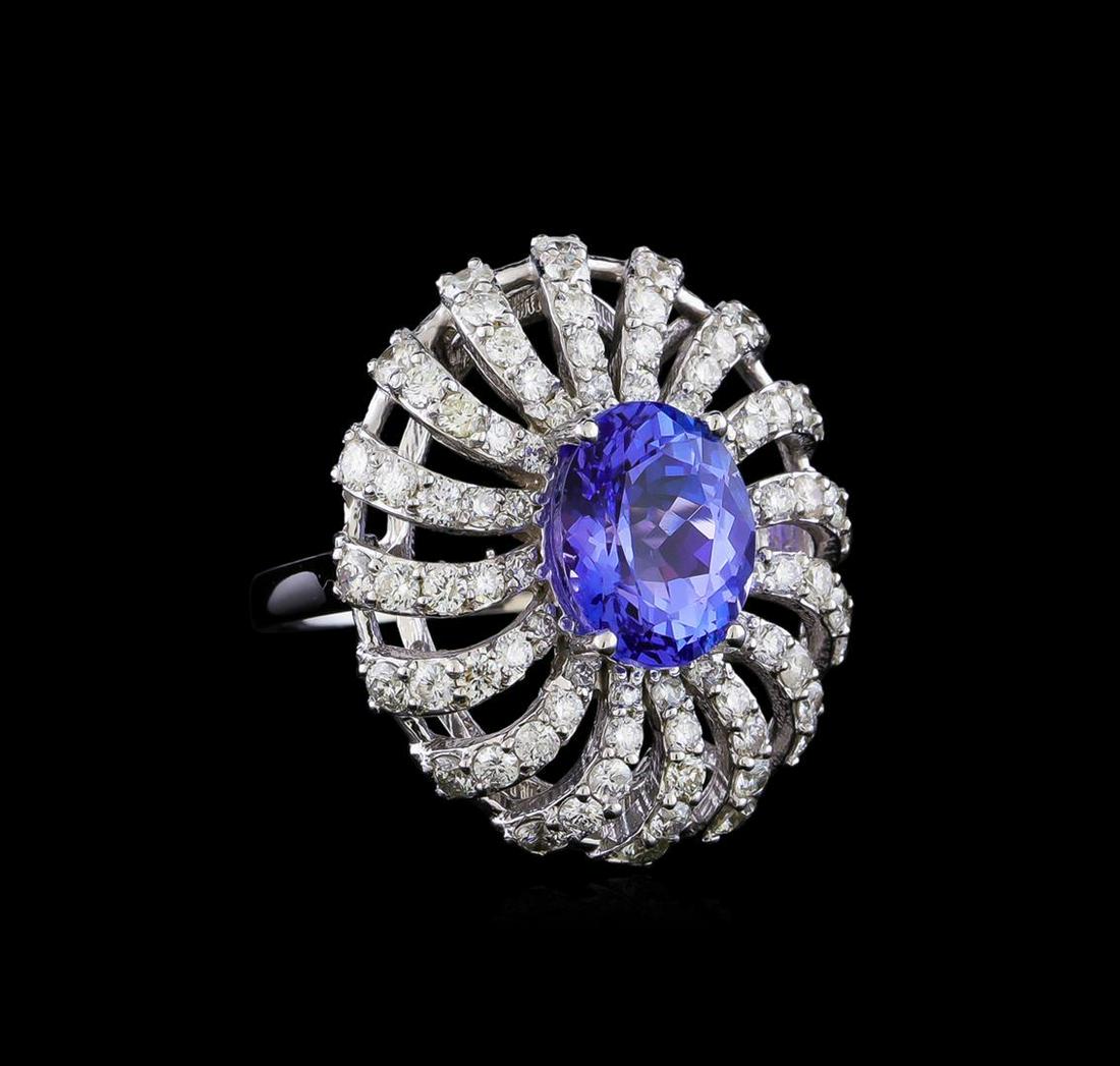 4.17 ctw Tanzanite and Diamond Ring - 14KT White Gold: One electronically tested 14KT white gold lady's cast fashion ring with a basket halo with a bright polish finish. The featured lady's ring has a shank measuring 2.01 millimeters in width. Identified 