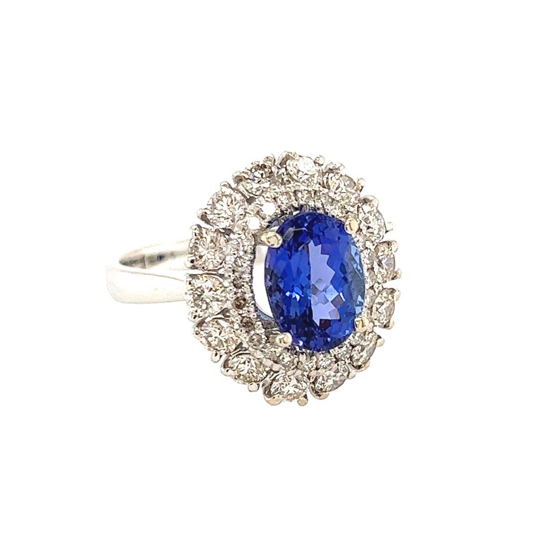 2.64 ctw Tanzanite & Diamond Ring - 14KT White Gold: One electronically tested 14KT white gold lady's cast fashion double basket halo ring with a tapered cathedral shank with a bright polish finish. Condition is new, good workmanship. The featured lady'