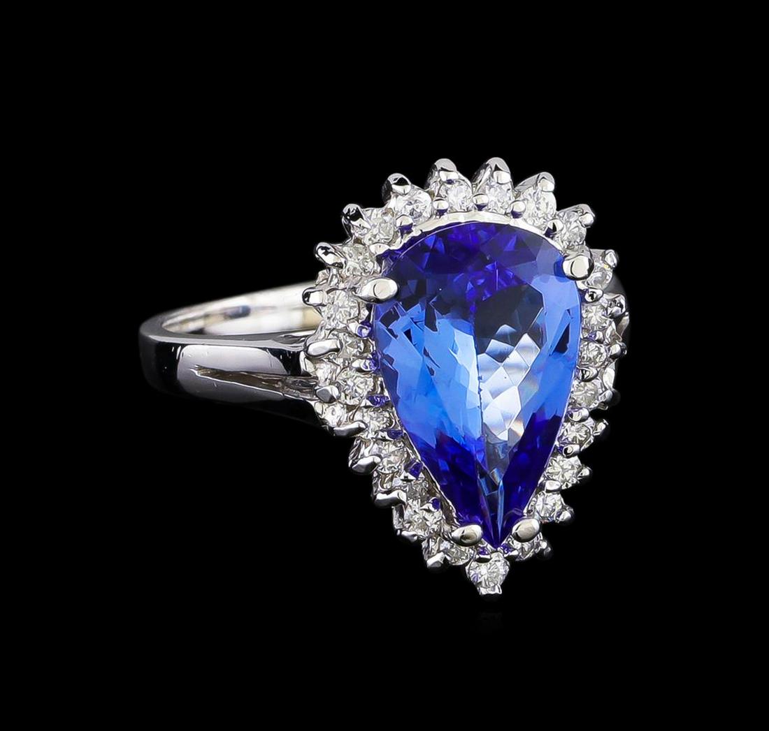 2.97 ctw Tanzanite and Diamond Ring - 14KT White Gold: One electronically tested 14KT white gold lady's cast fashion ring with a basket halo with a bright polish finish. The featured lady's ring has a shank measuring 2.04 millimeters in width. Identified 