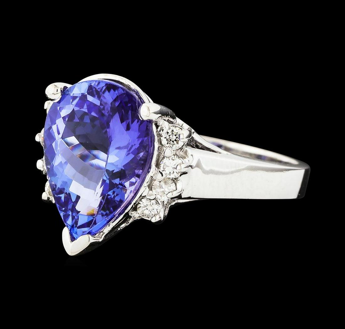 4.56 ctw Tanzanite and Diamond Ring - 14KT White Gold: One electronically tested 14KT white gold lady's cast fashion ring with a cathedral shank with a bright polish finish. The featured lady's ring has diamond set shoulders and a shank measuring 2.55 mil
