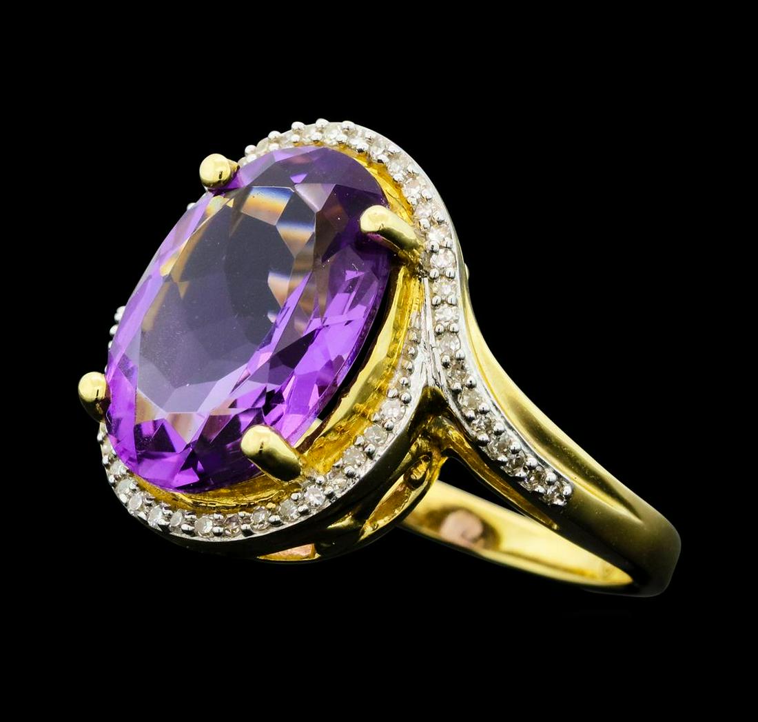 4.90 ctw Amethyst And Diamond Ring - 14KT Yellow Gold: One electronically tested 14KT yellow gold lady's cast fashion ring with a bypass halo with a bright polish finish. The featured lady's ring has a shank measuring 2.10 millimeters wide. Identified wit
