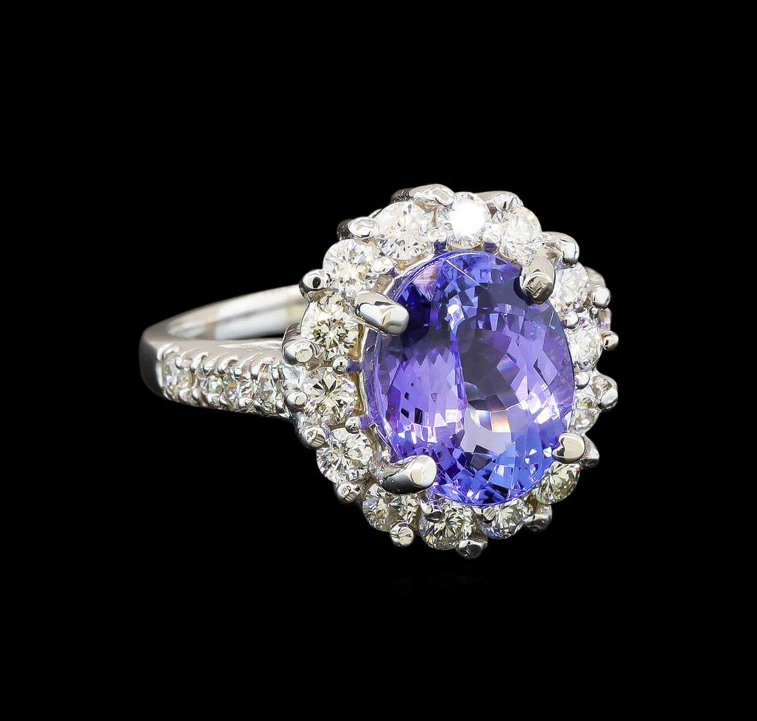 14KT White Gold 3.82 ctw Tanzanite and Diamond Ring: One electronically tested 14KT white gold ladies cast tanzanite and diamond ring with a bright polish finish. Identified with markings of "K14". Condition is new. Containing: One prong set oval modifi