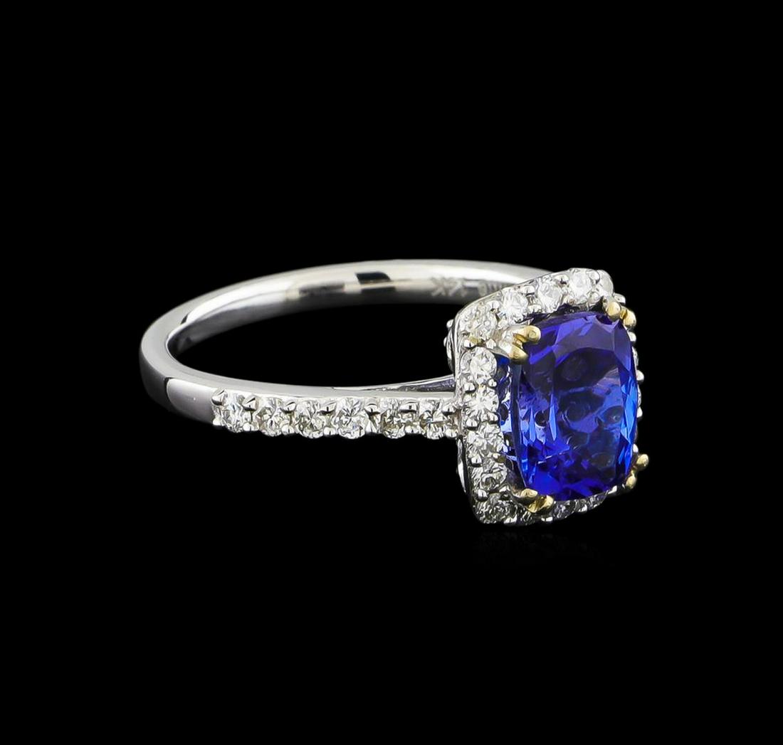 14KT White Gold 1.71 ctw Tanzanite and Diamond Ring: One electronically tested 14KT white gold ladies cast tanzanite and diamond ring with a bright polish finish. The featured tanzanite is set within a diamond ring supported by diamond set shoulders, co