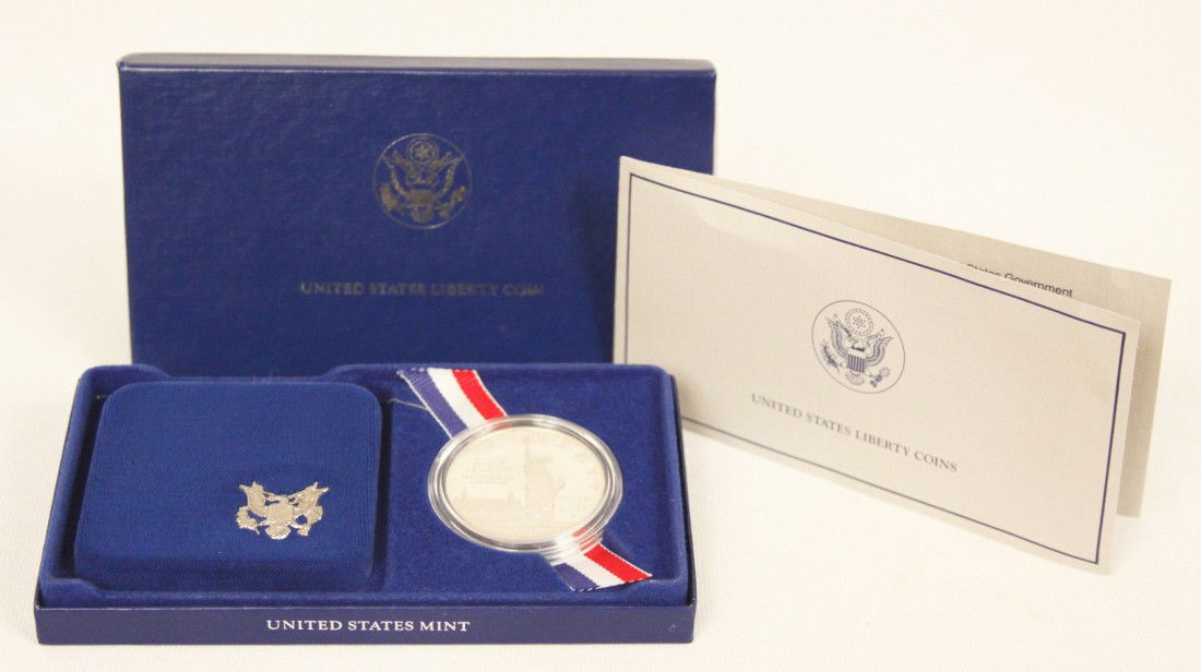 1986 Silver Ellis Island Proof Dollar Coin WBS38: "1986 Silver Ellis Island Proof Dollar Coin WBS38. As-Is Condition! YA63BL. One 18986 Silver Ellis Island Proof Dollar Coin. Comes with original box and information sheet. Also comes with decorative v