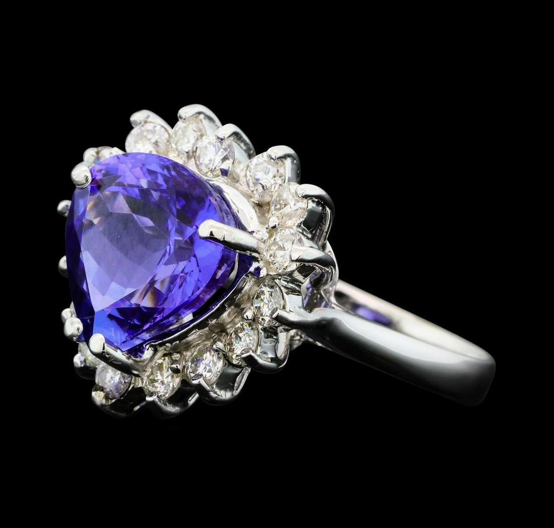 5.25 ctw Tanzanite And Diamond Ring - 14KT White Gold: One electronically tested 14KT white gold lady's cast fashion ring with a basket halo with a bright polish finish. The featured lady's ring has a shank measuring 2.91 millimeters wide. Identified with