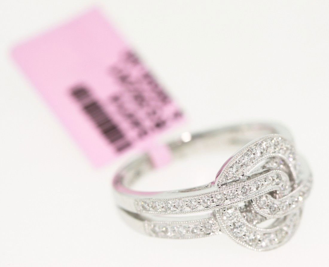 14KT White Gold .55ct Diamond Knot Design Ring FJM11: "14KT White Gold .55ct Diamond Knot Design Ring FJM11. Excellent Condition! EV603BK. 14KT white gold and diamond knot design ring. Features 52 round diamonds weighing a total of approximately 0.55cts.