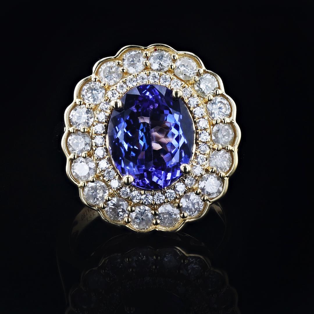 4.12 ctw Tanzanite and 1.57 ctw Diamond 14K Yellow Gold Ring: 4.12ct Tanzanite and 1.57ctw Diamond 14K Yellow Gold Ring. Please see Photos and Description for all available information. This is an excellent example of the versatility of a solitaire engagement ri