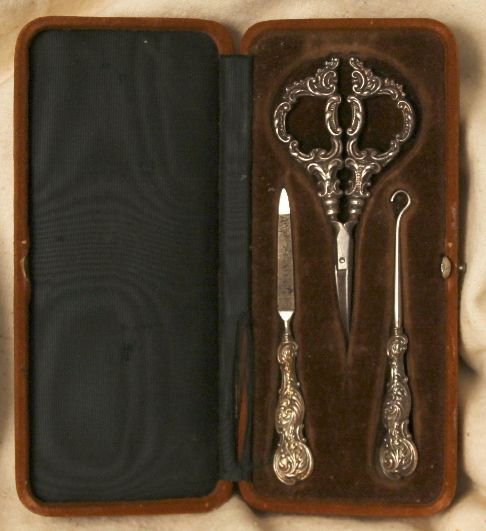 Antique Cased Sterling Vanity Set ED776: "Antique Cased Sterling Vanity Set ED776. Excellent Vintage Condition! NC171HF. This antique sterling vanity set comes in its original case. This set is valued at over $600.00. The scissors are marked