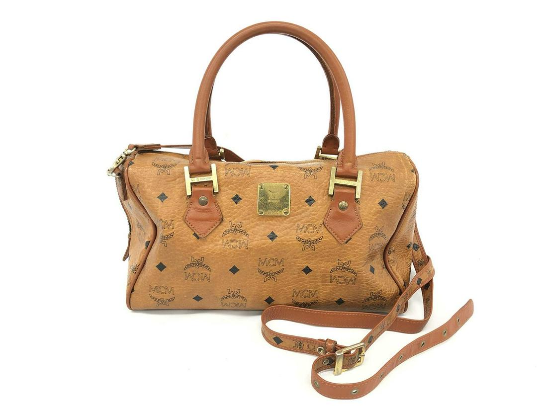 MCM Brown Monogram Visetos Canvas Leather Boston Bag: One MCM Brown Monogram Visetos Canvas Leather Boston Bag. Item is sold AS-IS. Please check photos and descriptions for all available details. MCM Brown Monogram Visetos Canvas Leather Boston Bag