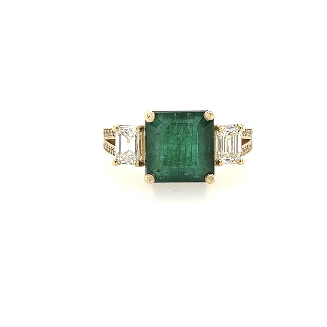 5.50 ctw Emerald and Diamond Ring - 14KT Yellow Gold: One electronically tested 14KT yellow gold lady's custom CAD/CAM fashion ring with a three stone motif with a bright polish finish. Condition is new, good workmanship. The featured lady's ring has a s