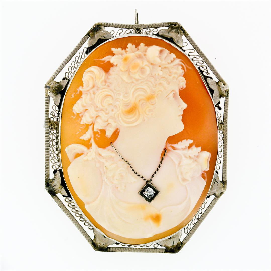 Antique Art Deco 14k White Gold Cameo Round Diamond Filigree Brooch Pin Pendant: An art deco solid 14k white gold filigree brooch with 1 oval shaped carved shell cameo (45.2x34.4mm) and 1 round single cut natural diamond (G - VS2; 0.06ct). Measures 50.32x39.87mm and weighs a total