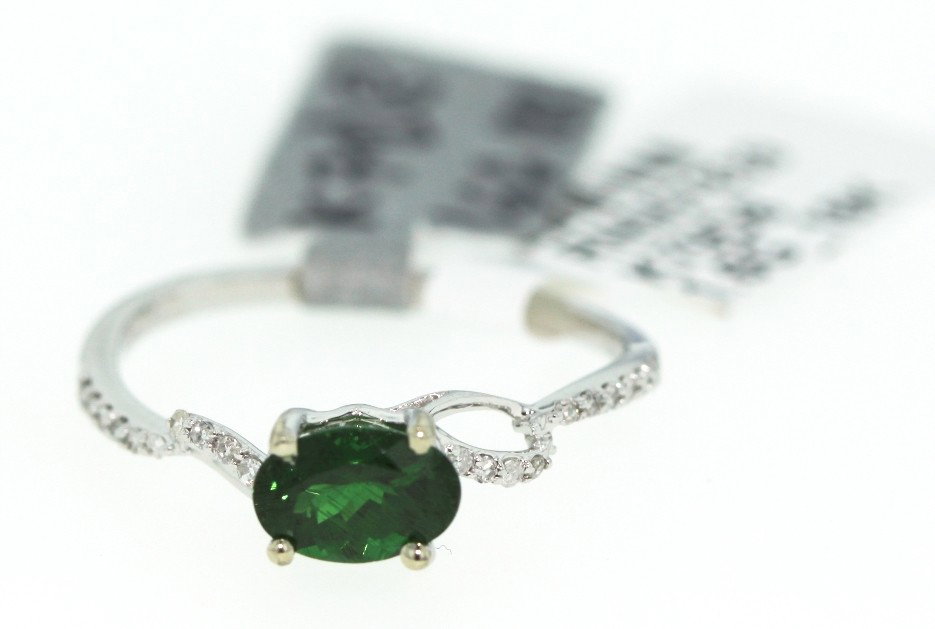 18KT White Gold .89ct Tsavorite and Diamond Ring RM98: "18KT White Gold .89ct Tsavorite and Diamond Ring RM98. New Condition! ET162VY. One lady's polished, stamped and electronically tested solid 18KT white gold ring mounted with: 1 genuine tsavorite (gro