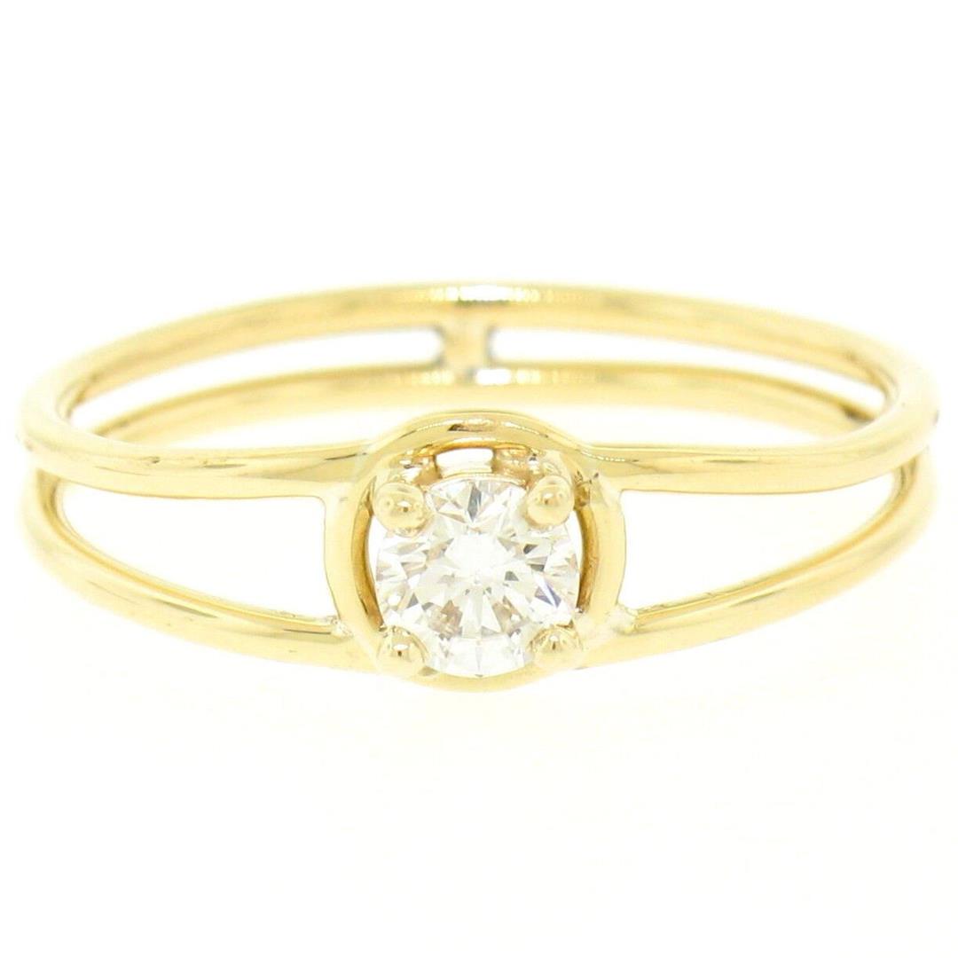 14k Solid Yellow Gold 0.21 ctw Round Brilliant Diamond Solitaire Open Band Ring: An estate solid 14k yellow gold solitaire open band ring, with 1 round brilliant cut natural diamond (H- VS1; 0.21ct). The ring is size 5.0, weighs a total of 1.7 grams, and measures 5.6mm wide.