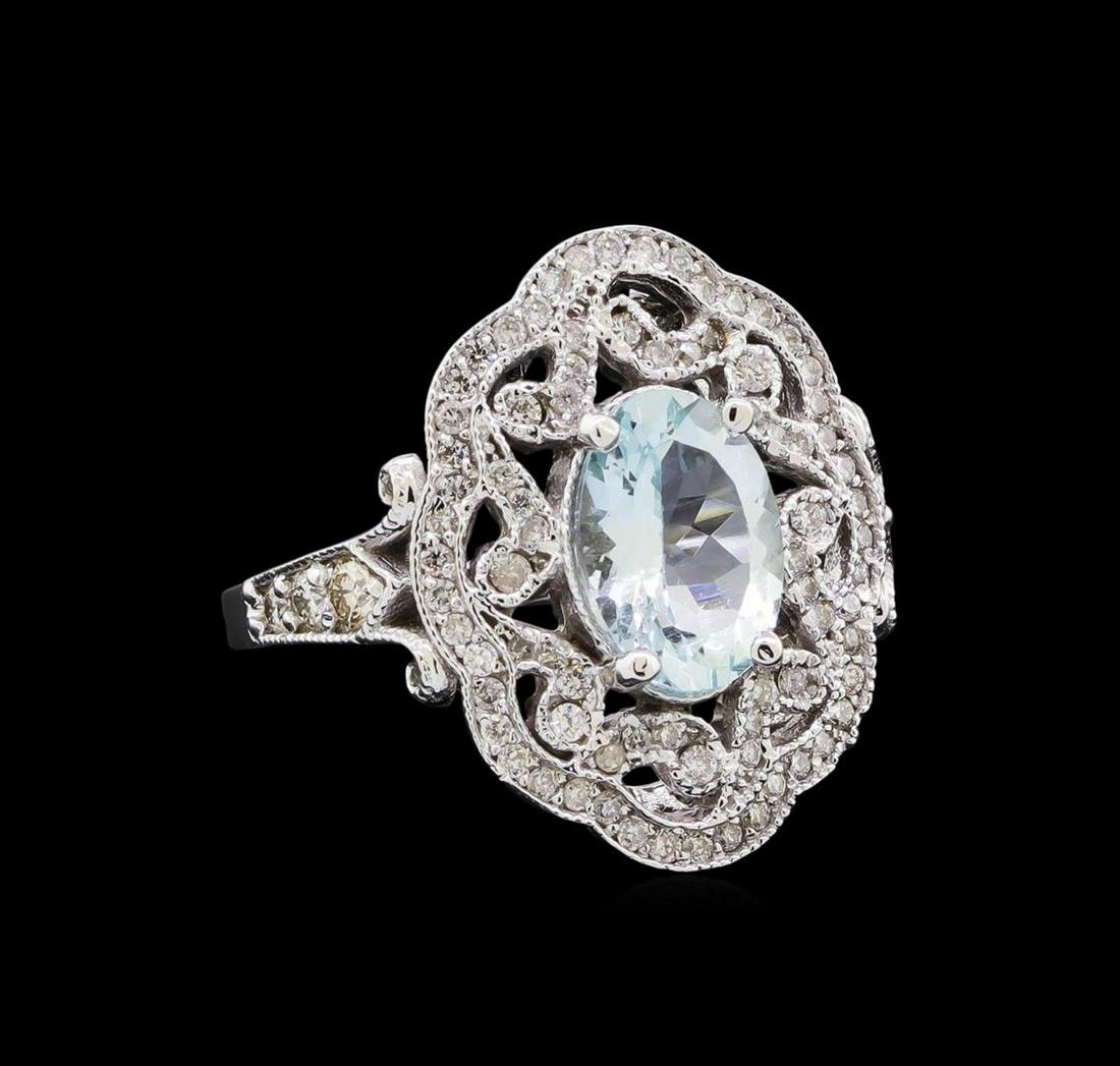 1.92 ctw Aquamarine and Diamond Ring - 14KT White Gold: One electronically tested 14KT white gold lady's cast fashion ring with a scalloped halo with a bright polish with milgrain detailing finish. The featured lady's ring has a shank measuring 1.85 millim