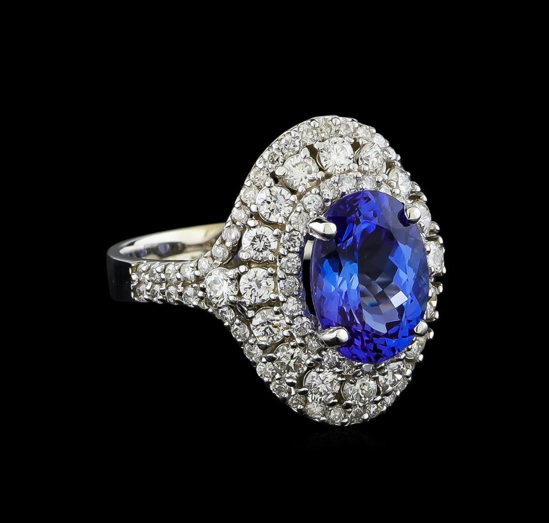 2.93 ctw Tanzanite and Diamond Ring - 14KT White Gold: One electronically tested 14KT white gold lady's cast fashion ring with a triple halo with a bright polish finish. The featured lady's ring has a shank measuring 3.13 millimeters wide. Identified with