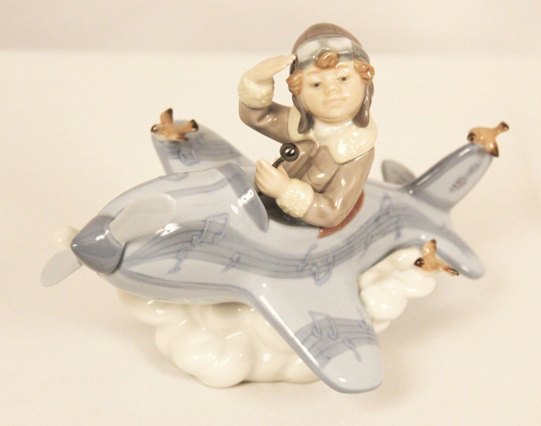 Retired Lladro "Over the Clouds" WBL47: "Retired Lladro "Over the Clouds" WBL47. Excellent Condition! TU102RE. This is one of the most delightful of Lladro's figurines, "Over the Clouds", which features a young boy piloting his own plane. A