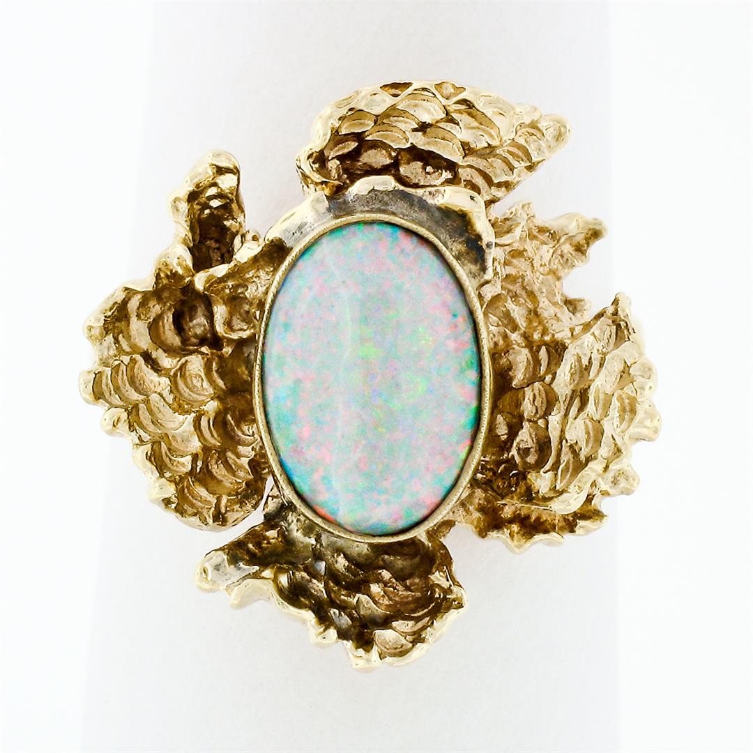 Vintage 14k Gold Oval Opal Solitaire & Nugget Textured Free Form Cocktail Ring: A vintage 14k yellow gold freeform nugget style ring with 1 oval cabochon cut natural opal (10.05x7.02mm). The ring is size 7.0, weighs a total of 5.48 grams, and measures 19.04mm wide.
