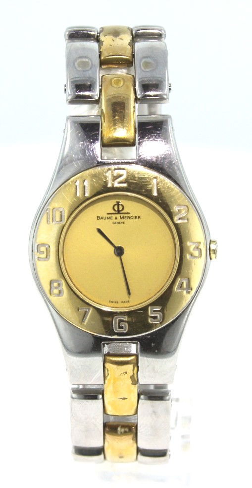 Baume and Mercier Mid Size Two Tone Linea 5151 Watch HM: "Baume and Mercier Mid Size Two Tone Linea 5151 Watch HM1. Fine Condition! JZ154ML. It features a case and push down back plate made from a solid and durable stainless steel. The bezel is gold plated