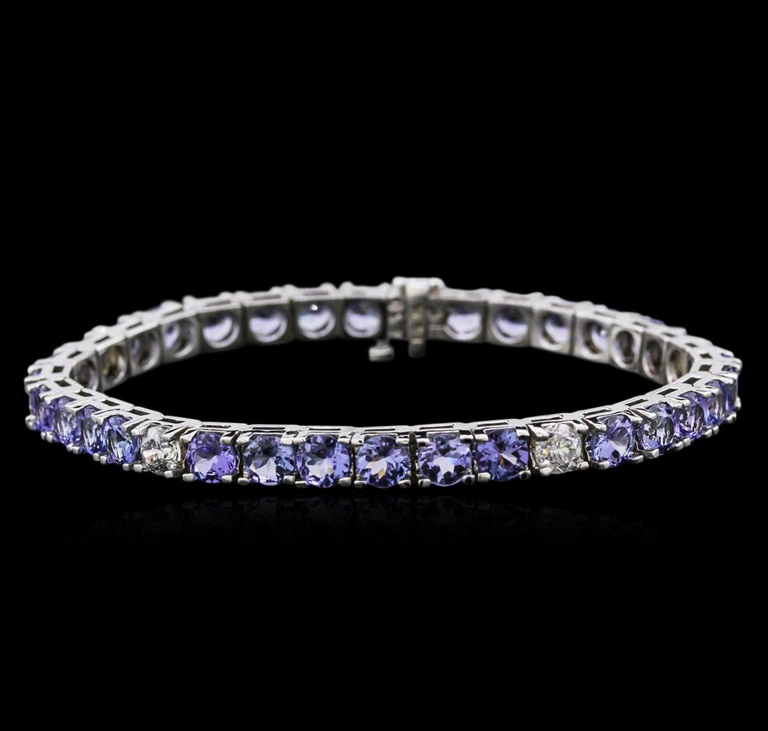 14KT White Gold 13.13 ctw Tanzanite and Diamond Bracelet: One electronically tested 14KT white gold ladies cast tanzanite and diamond bracelet with a hidden box clasp with safety closer with a bright polish finish. Measurements: 7" in length Identified with 