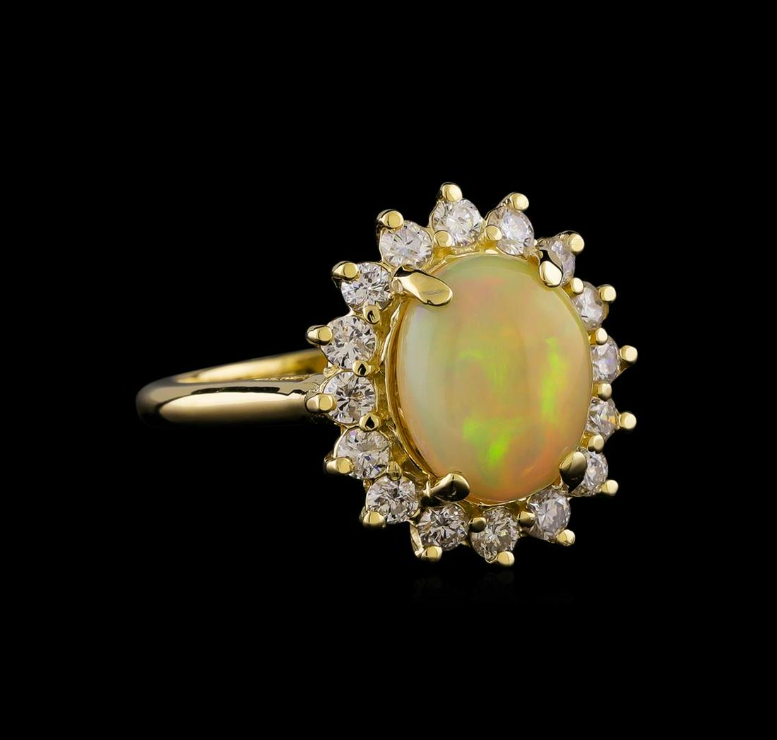 1.90 ctw Opal and Diamond Ring - 14KT Yellow Gold: One ring : 14KT yellow gold weighing 5.37gm containing one opal center stone with a total weight of 1.90 ct. and side diamonds weighing 0.75ctw.