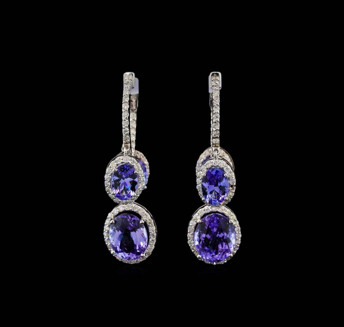 14KT White Gold 8.10 ctw Tanzanite and Diamond Earrings: One pair electronically tested 14KT white gold ladies cast tanzanite and diamond earrings with hinged clip backs with a bright polish finish. Identified with markings of "14K". Condition is new. Conta