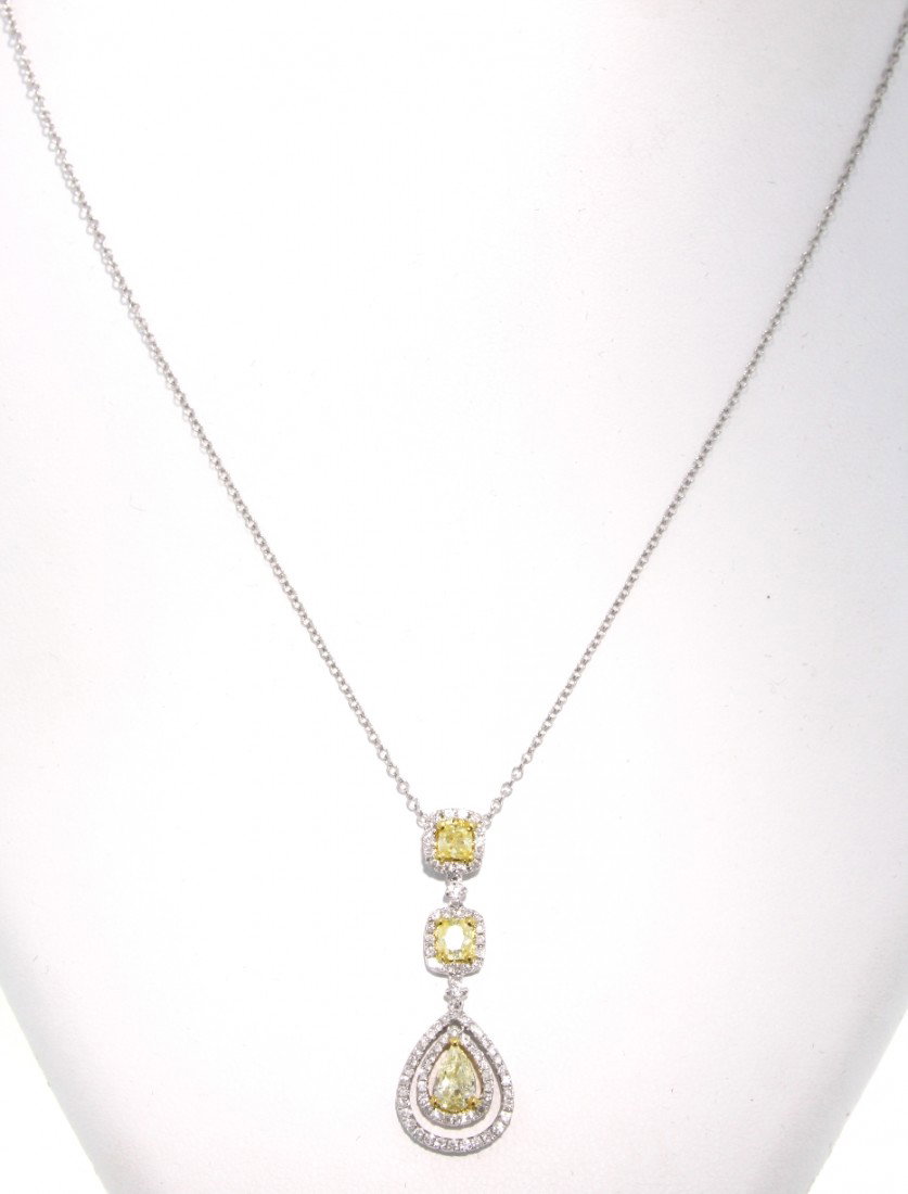 18KT White Gold Yellow and White Diamond Pendant and Ch: "18KT White Gold Yellow and White Diamond Pendant and Chain FJM1111. Excellent Condition! MQ4921GD. One 18KT white gold yellow and white diamond pendant and chain. Features 3 fancy yellow diamonds wei